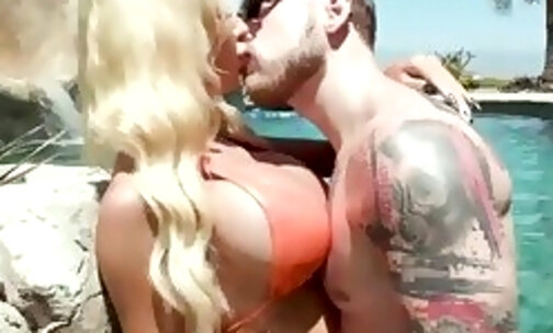 Steve Rickz pulls down Brittney Kades bikini top so he can touch and taste her breasts