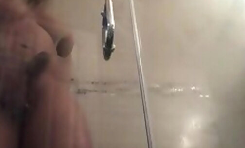 Stroking her big cock and busting a nut in the shower
