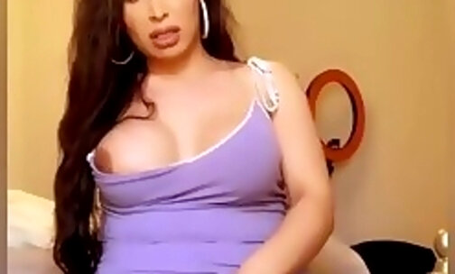 Stroking her cock in a purple dress and shooting a cumshot